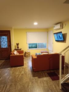 a living room with two couches and a window at Melo 2203 Duplex 1 in Belén de Escobar