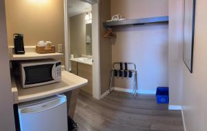 a small bathroom with a microwave on a counter at Hawberry Motel in Little Current +50 photos