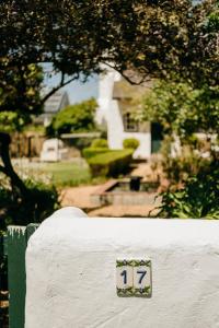 a sign on a wall with a house in the background at Finchlea Cottage in Stanford +7 photos