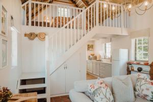 a living room with a staircase and a couch at Finchlea Cottage in Stanford