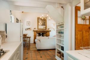 a kitchen and living room with a couch and a fireplace at Finchlea Cottage in Stanford