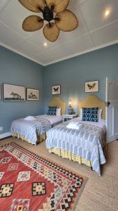 a bedroom with two beds and a ceiling fan at Stanford Villa in Stanford