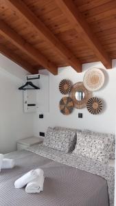 a bedroom with a bed and a wooden ceiling at Saos Terra Suites in Samothraki