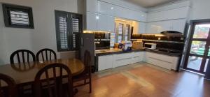 a kitchen with a table and a kitchen with white cabinets at Square Accommodation Rudra kunj in Pokhara
