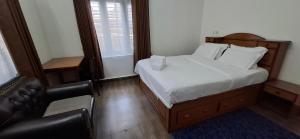a small bedroom with a bed and a couch at Square Accommodation Rudra kunj in Pokhara