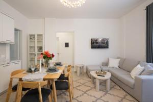a living room with a couch and a table at Oasis White in Durrës