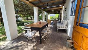 a wooden table and chairs on a patio at Lavender’s Blue in Stanford