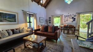 a living room with a couch and a table at Lavender’s Blue in Stanford