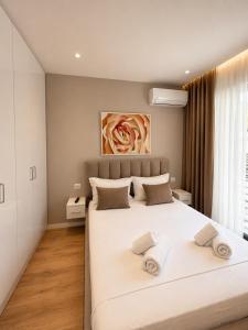 a bedroom with a large white bed with two pillows at ODA Central Stay in Elbasan