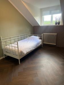 a bedroom with a bed and a window at Apartment Målargården in Uddeholm