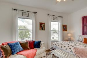 a bedroom with a bed and a couch and two windows at < 1 Mi to Georgetown Square & SU! Extended Base in Georgetown