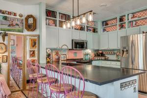 a kitchen with pink chairs and a counter with a refrigerator at < 1 Mi to Georgetown Square & SU! Extended Base in Georgetown