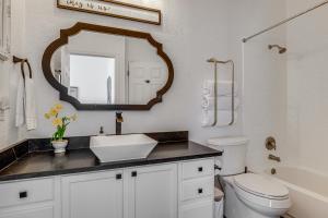a bathroom with a sink and a toilet and a mirror at < 1 Mi to Georgetown Square & SU! Extended Base in Georgetown +19 photos