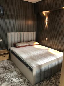 a bedroom with a large bed with a white mattress at Studio - JONIKA in Tashkent