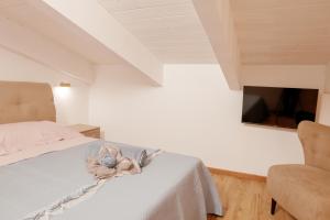 a bedroom with a bed with a stuffed animal on it at Domo De Uccio in Alghero