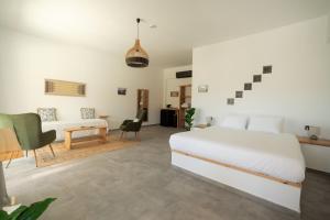 a bedroom with a bed and a desk and a couch at Thyme Suite in Paránimfoi +23 photos