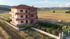 a house in the middle of a field at Vila Lian Apartaments in Belsh