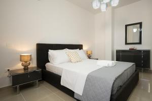 a bedroom with a large bed with two night stands at Oasis White in Durrës