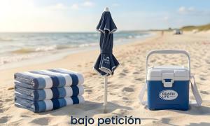 a beach towel and an umbrella on the beach at Casa de Silvia in Arrecife