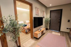 a living room with a large mirror and a television at Cozy Studio Apartment in Sheikh Zayed in Sheikh Zayed