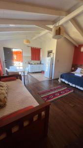 a living room with a bed and a dining room at Descanso de las Piedras in Tafí del Valle +70 photos