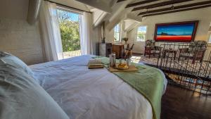 a bedroom with a bed with a table in it at Riverside Cottage in Stanford +47 photos