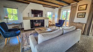 a living room with a couch and a fireplace at Riverside Cottage in Stanford