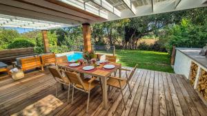 a wooden deck with a table and chairs on it at Riverside Cottage in Stanford