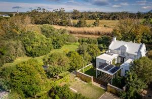 an aerial view of a white house with solar panels on it at Riverside Cottage in Stanford