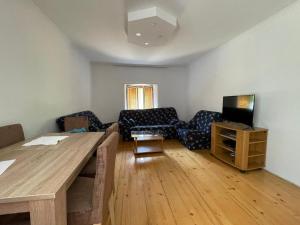 a living room with a table and a couch at Heaven Retreat in Vusanje