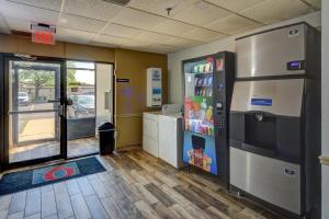 a kitchen with a refrigerator and a door to a store at Motel 6-Libertyville, IL in Libertyville