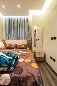 a bedroom with a bed with a blanket on it at Cozy Studio Apartment in Sheikh Zayed in Sheikh Zayed