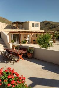 a house with a table and chairs and flowers at Lavender Suite in Paránimfoi
