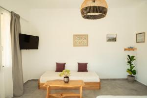 a bedroom with a bed and a table and a tv at Lavender Suite in Paránimfoi