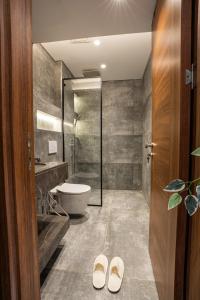 a bathroom with a shower and a toilet and a sink at Cozy Studio Apartment in Sheikh Zayed in Sheikh Zayed +18 photos