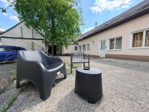 a chair and a table in front of a house at E&C Pension Rooms in Vienna
