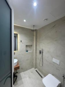 a bathroom with a toilet and a sink and a shower at Hotel Barjami in Sarandë +49 photos
