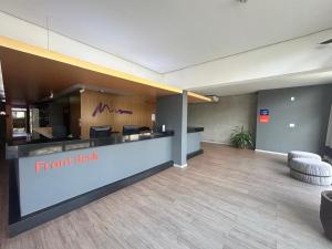an empty lobby with a front desk in a building at Vista Inn Express Contagem in Contagem