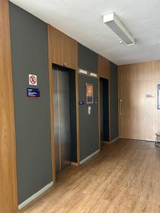 an empty room with two elevators in a building at Vista Inn Express Contagem in Contagem