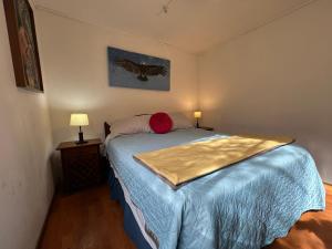 a bedroom with a bed with a blue comforter at Oceana Suites Refugio de Maipo in San José de Maipo +63 photos