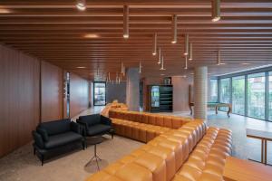 a living room with a large couch and two chairs at GO24 by LikeHome in Auxiliadora