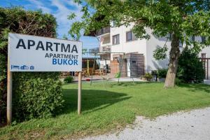 a sign in front of a house with a building at Apartments Bukor with seasonal pool in Lukovica pri Domžalah +72 photos
