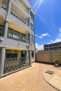 an apartment building with balconies and a patio at The Legend Place in Eldoret