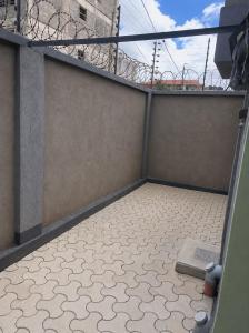 a balcony with a tiled floor on a building at The Legend Place in Eldoret +1 photo