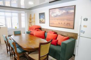 a living room with a green couch and a table at Apricot Lodge in Bishkek