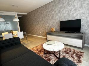 a living room with a couch and a flat screen tv at Dessau VI in San Luis