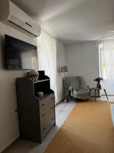 a living room with a dresser and a bedroom at ΑtoZ studio in Hydra in Hydra