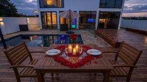 a wooden table with a valentines heart on it at White house Residences by Pebbles in Lusaka