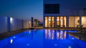 a swimming pool in the middle of a house at night at White house Residences by Pebbles in Lusaka