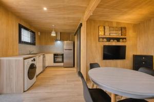 a kitchen and dining room with a table and chairs at Studio bois Le Colibri à Chambley in Hagéville